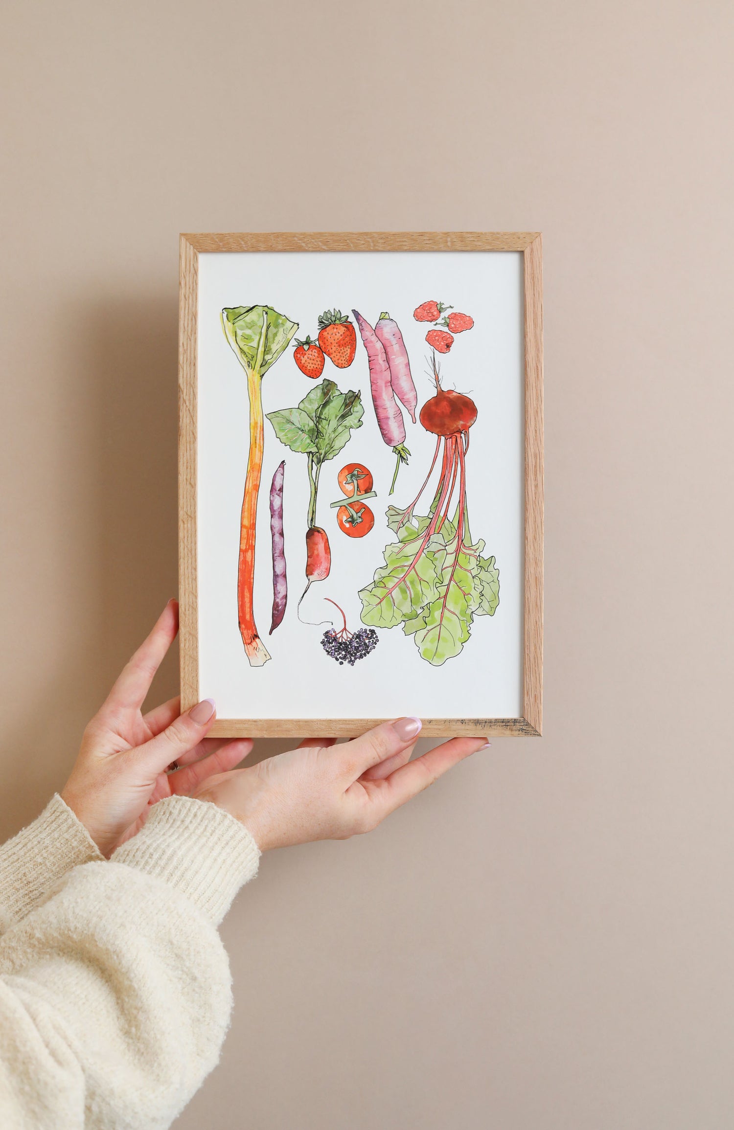 Hands holding art for cottagecore aesthetic featuring colourful vegetables from a nature lovers allotment